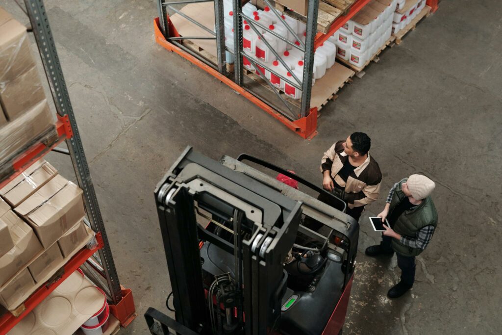 Employees Standing beside Forklift 